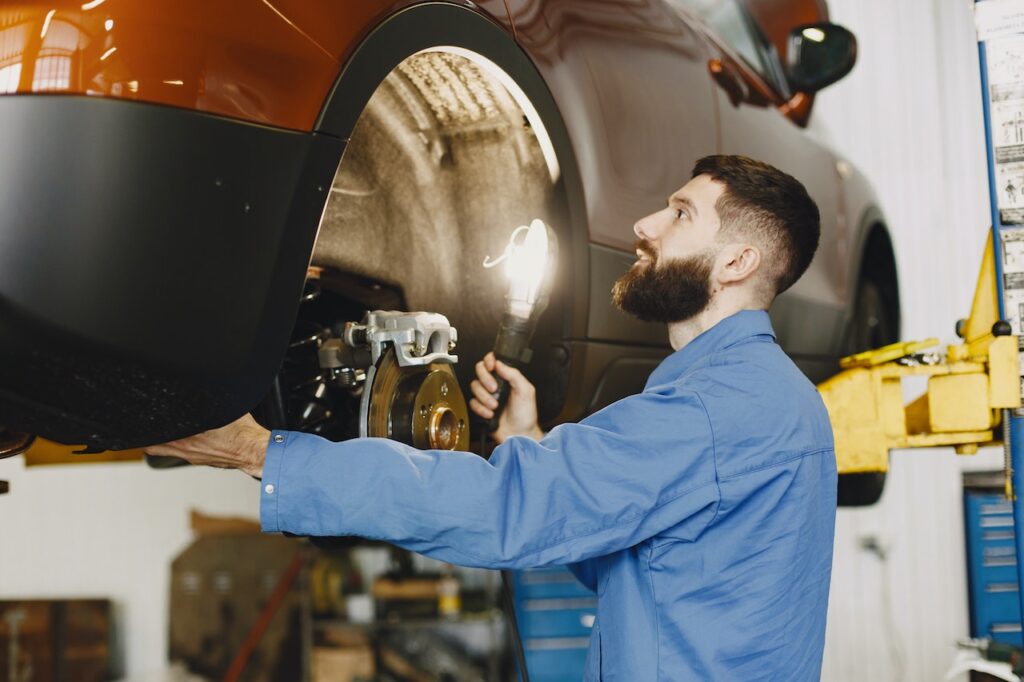 mechanic checking car's brake system