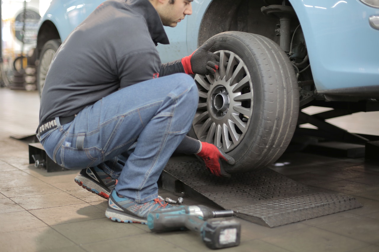 man inspecting tires
